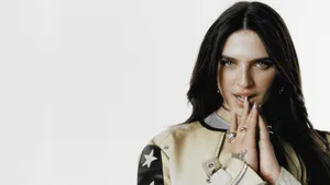 Mae Muller Striking A Pose On Stage Wallpaper