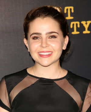 Mae Whitman Striking A Pose In A Chic Outfit Wallpaper