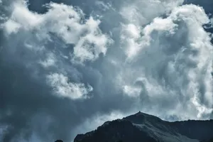 Magnificent Cumulonimbus Clouds Over Majestic Mountain Wallpaper