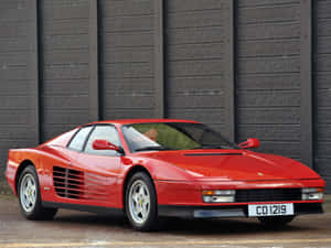 Magnificent Ferrari Testarossa On A Scenic Road Wallpaper