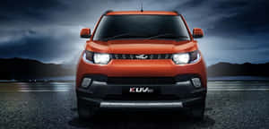 Mahindra Xuv500 On A Picturesque Mountain Road Wallpaper