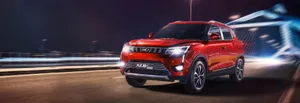 Mahindra Xuv500 Suv On A Scenic Road Wallpaper