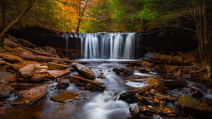 Majestic 4k Waterfall In Natural Surroundings Wallpaper