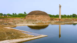 Majestic Ashoka Pillar At Ananda Stupa Wallpaper