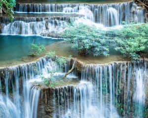 Majestic Aurora Borealis Over A Serene Landscape Wallpaper