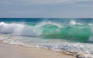 Majestic Beach Waves At Sunset Wallpaper