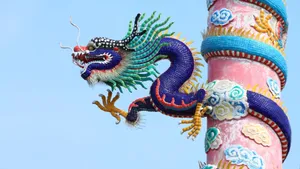 Majestic Blue Dragon Perched On A Cliff Wallpaper