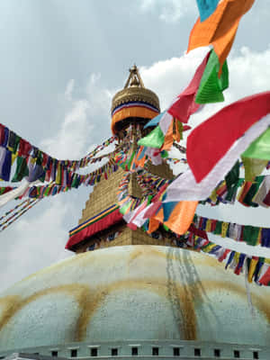 Majestic Boudhanath Stupa Adorned With Colorful Prayer Flags Wallpaper