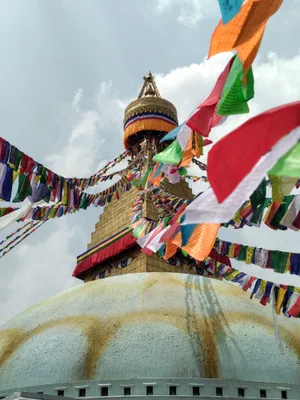 Majestic Boudhanath Stupa Adorned With Colorful Prayer Flags Wallpaper