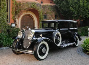 Majestic Cadillac Fleetwood In Vintage Setting Wallpaper