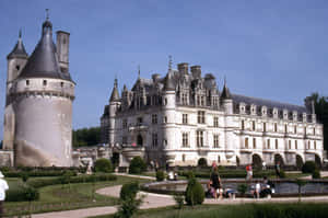 Majestic Château De Chenonceau Brimming With Tourists Wallpaper