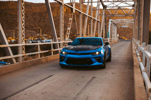 Majestic Chevrolet Camaro On A Bridge Wallpaper