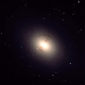 Majestic Elliptical Galaxy In Deep Space Wallpaper