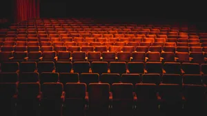 Majestic Empty Theater With Red Chairs Wallpaper