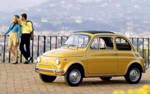 Majestic Fiat Cinquecento Parked On A Picturesque Street Wallpaper