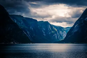 Majestic_ Fjord_ Under_ Stormy_ Skies.jpg Wallpaper