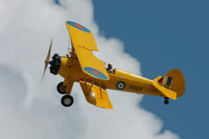 Majestic Flight Of A Vintage Airplane Wallpaper