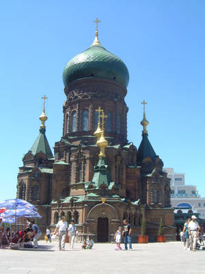 Majestic Green Church Against Clear Blue Sky In Harbin Wallpaper