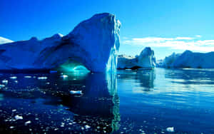 Majestic Iceberg Floating In Blue Ocean Wallpaper