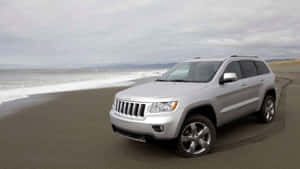 Majestic Jeep Grand Cherokee On A Rustic Terrain Wallpaper