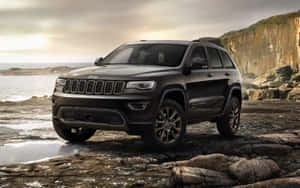 Majestic Jeep Grand Cherokee On Rugged Terrain Wallpaper