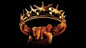 Majestic King Crown In Glittering Gold Wallpaper