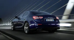 Majestic Maserati Ghibli Roaring Down The Road Wallpaper