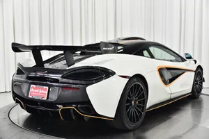 Majestic Mclaren 620r Racing On The Track Wallpaper