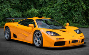 Majestic Mclaren F1 Speeding Down The Road Wallpaper