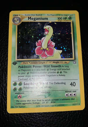 Majestic Meganium Pokemon Trading Card On Leather Background Wallpaper