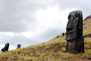 Majestic Moai Statues On The Rugged Terrains Of Easter Island, Chile Wallpaper