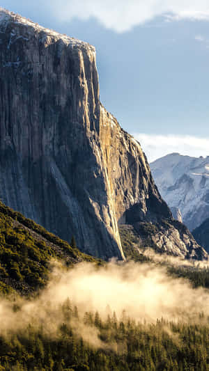 Majestic_ Mountain_ Cliff_ Above_ Fog Wallpaper