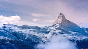 Majestic_ Mountain_ Peak_ Above_ Clouds Wallpaper