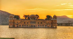 Majestic Mountain Summit Overlooking A Lake Wallpaper
