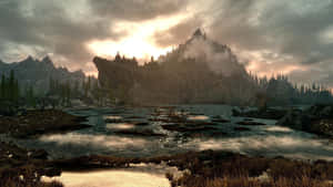 Majestic Mountains And Serene River In The Stunning World Of Skyrim Wallpaper