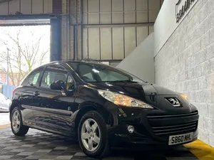 Majestic Peugeot 207 Cruising On The Road Wallpaper