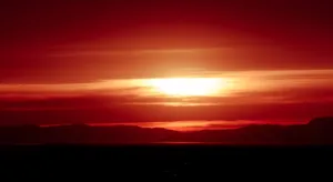 Majestic Red Sunset Over The Horizon Wallpaper