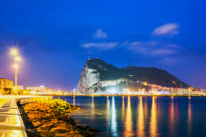 Majestic Rock Of Gibraltar Illuminated At Night Wallpaper