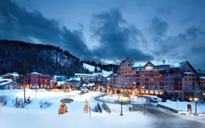 Majestic Ski Resort With Snow-covered Mountains Wallpaper