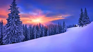 Majestic Snowy Landscape At Sunrise Wallpaper