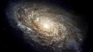 Majestic Spiral Galaxy Unfolding In Deep Space Wallpaper