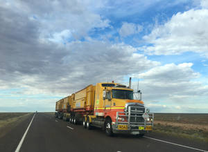 Majestic Trailer Truck Journeying Along Arcoona Highway Wallpaper