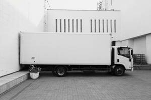 Majestic Trailer Truck Parked At A Commercial Building Wallpaper