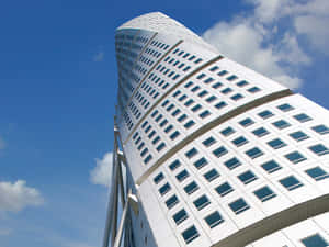 Majestic Turning Torso Skyscraper Reaching Into The Blue Sky Wallpaper