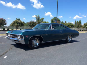 Majestic Turquoise Chevrolet Impala 1967 In All Its Glory Wallpaper