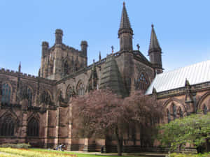 Majestic View Of Chester Cathedral Amidst Greenery Wallpaper