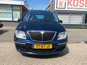 Majestic View Of Lancia Phedra On Asphalt Road Wallpaper