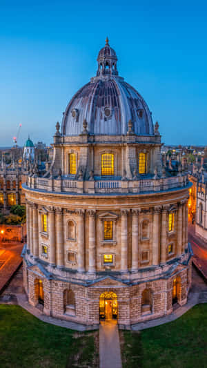 Majestic View Of Radcliffe Camera In Oxford University At Nighttime Wallpaper