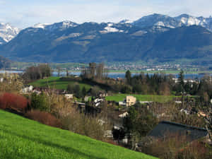 Majestic View Of Rapperswil-jona Skyline At Sunset Wallpaper