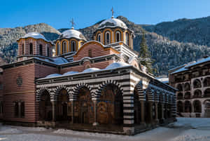 Majestic View Of Rila Monastery Amidst The Bulgarian Mountains Wallpaper